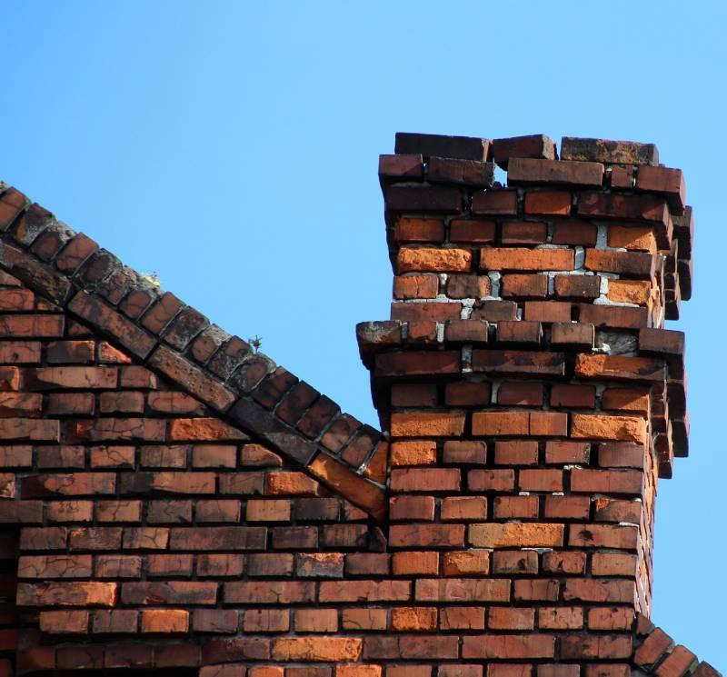 Damaged chimney on an Ann Arbor home showing cracks and missing mortar